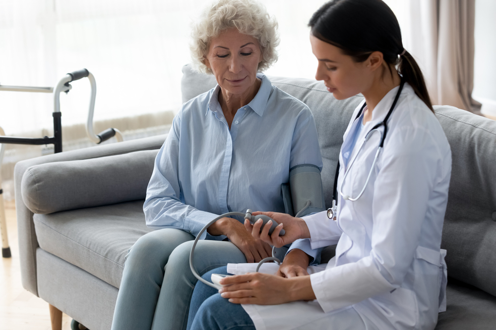Female doctor caring for an older patient.
