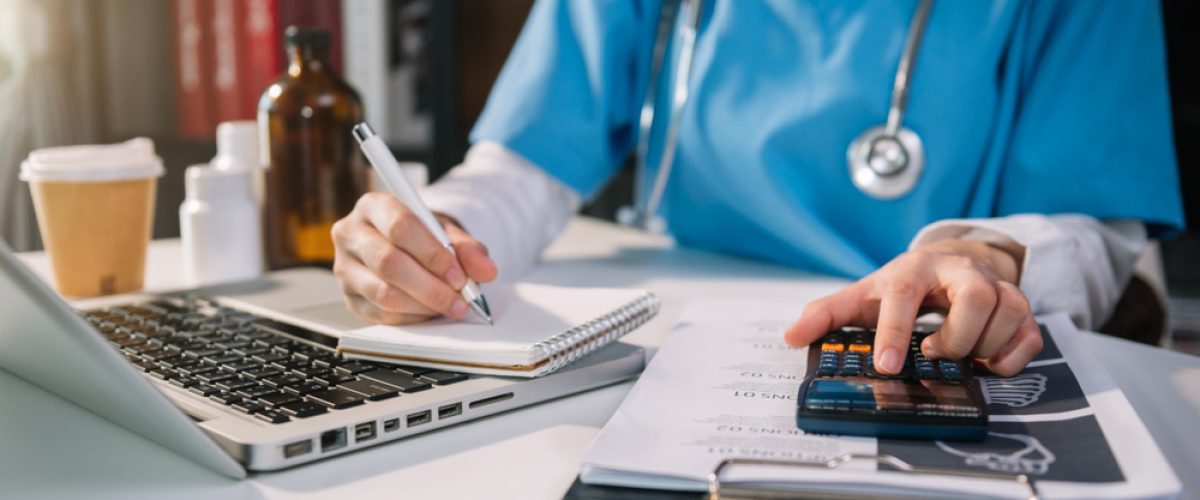 Doctor adding up expenses.
