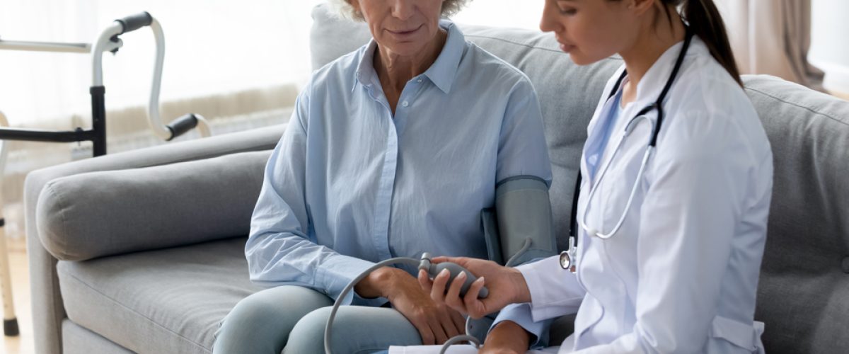 Female doctor caring for an older patient.